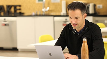 John Simpson, founder of Digital Health Strategies healthcare marketing agency, and a healthcare digital marketing expert, working at his laptop
